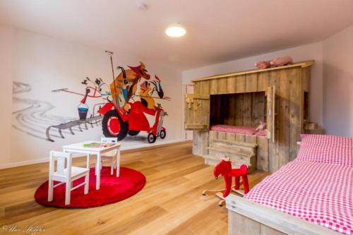 HerrentierbachFerienhaus Rote Sau的一间卧室配有一张床铺和一张桌子,铺有红色地毯。