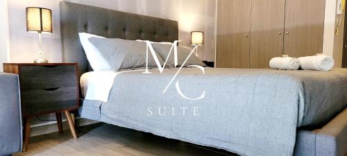 安托法加斯塔MC SUITE Centro - Edificio Coliving的一间卧室,配有一张带套房标志的床