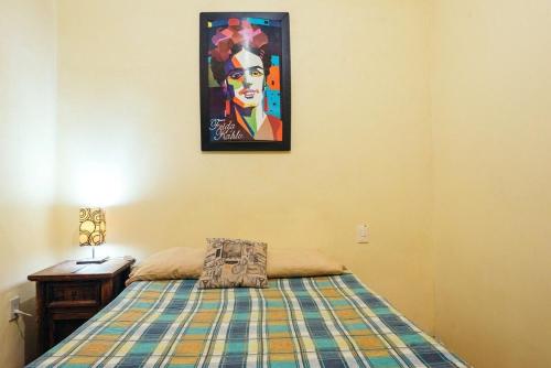 墨西哥城Mejor precio ubicación 2p habitación cómoda的卧室配有一张床,墙上挂着一幅画