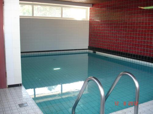 库克斯港Watten-Blick 2的墙上设有蓝色瓷砖的大型游泳池