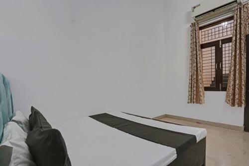 坎普尔SPOT ON Shree Sarveshwar Party Lawn And Hotel的白色的客房设有床和窗户。