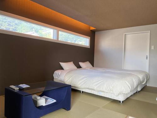 小樽Stay`sOTARU的一间卧室配有一张床、一张桌子和一个窗户。