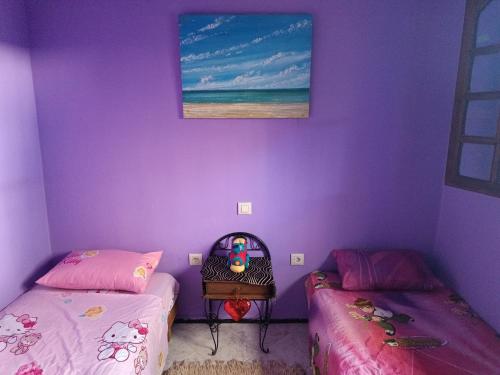 塞拉Dar Dyafa的紫色墙壁客房的两张床