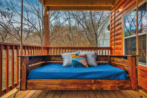 鸽子谷cul-de-sac Cabin on Parkway, 2King Beds & Bunk Beds, Hot Tub, Arcade Games的小木屋门廊上的一张床位