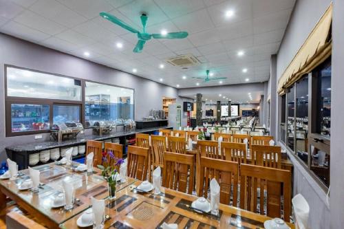 吉婆岛Cat Ba Central的一间带木桌椅的餐厅和一间酒吧