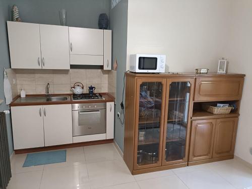 佩斯卡拉Short Lets Pescara的小厨房配有白色橱柜和微波炉