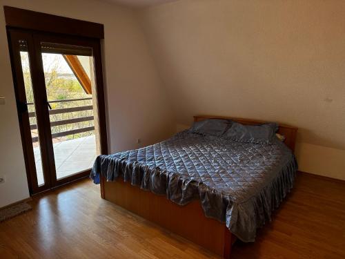 布尔奇科VIKENDICA TOJA - Brcko的一间卧室设有一张床和一个滑动玻璃门
