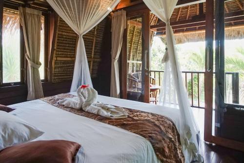 蓝梦岛Abian Huts Dream Beach Lembongan的一间卧室,配有一张大象床