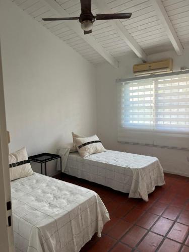 维多利亚Homestay Victoria Entre Rios的一间卧室配有两张床和吊扇