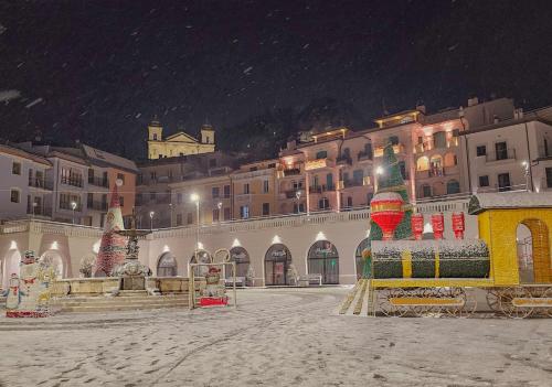桑格罗堡Appartamento relax Svitlana的一座白雪覆盖的城市,在晚上与一座建筑共建