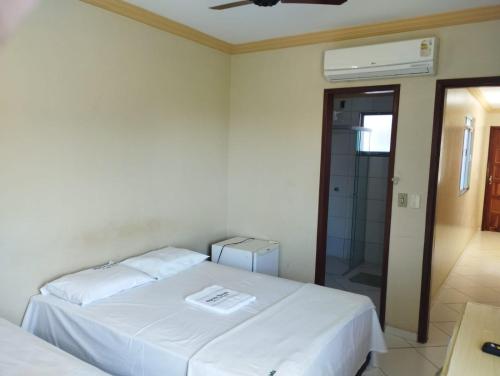 邦热苏斯-达拉帕Hotel Algaroba Anexo的一间卧室设有两张床和玻璃淋浴间