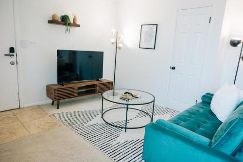 盐湖城Monthly Rate Special - Heart of SLC的客厅配有蓝色的沙发和玻璃桌