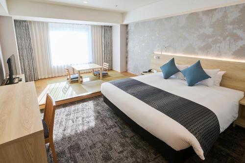 成田成田东武机场酒店的一间卧室配有一张带蓝色枕头的大床