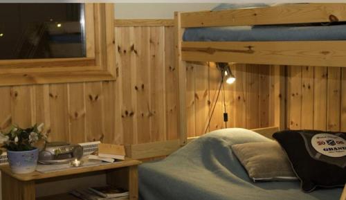 Årsunda奥桑达浴场酒店的一间卧室设有一张床和木墙