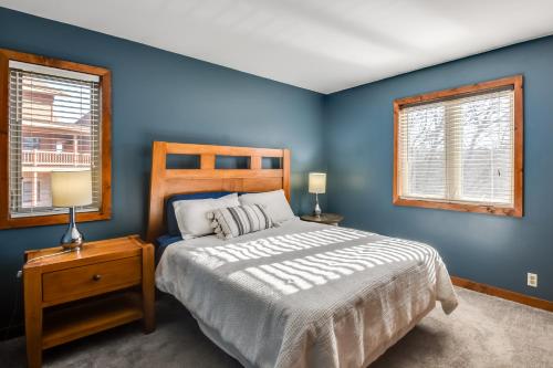 加利纳Cozy Illinois Abode with Deck and Grill, Near Golfing!的一间蓝色卧室,配有床和2个窗户