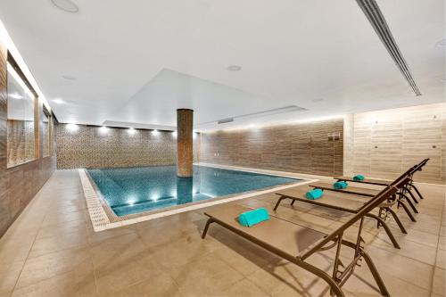 英雄港杜卡拉科尔酒店的一个带桌椅的房间的游泳池