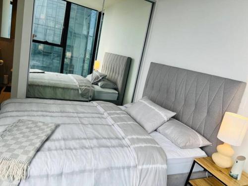 墨尔本2 BR Apartment Melbourne Square的一间卧室设有一张床和一个大窗户