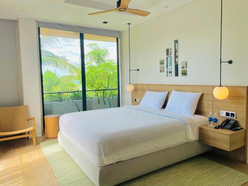 富国Moon Villa Phu Quoc - 3 Bedroom - Private pool的一间带大床的卧室和一个阳台