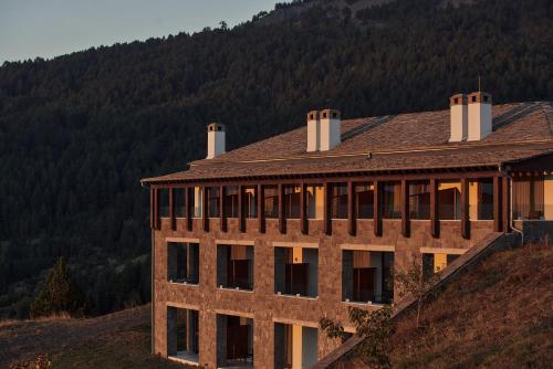 美特索文Grand Forest Metsovo - Small Luxury Hotels of the World的山边的建筑