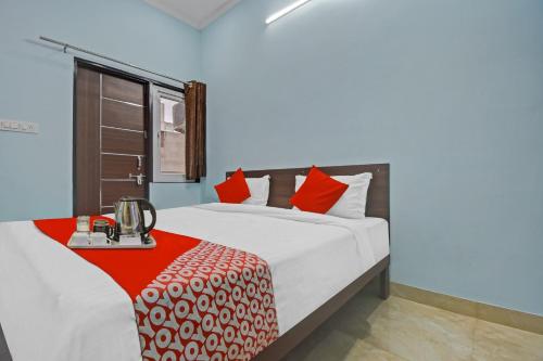 斋浦尔Flagship Hotel Ansh Plaza的一间卧室配有一张带红色枕头的大床