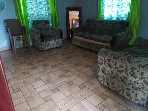 Paso AnchoCabaña Don Chacon的带沙发、椅子和绿色窗帘的客厅