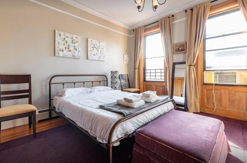 纽约Amazing 3 Bedroom Apartment的一间卧室配有一张床、一把椅子和窗户。