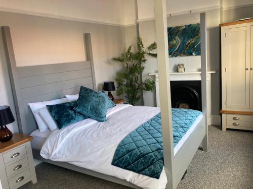 约维尔Stylish Flat in Yeovil Somerset的一间卧室配有一张带蓝色枕头的大床