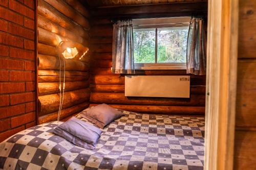 库萨莫Aamun Kajo的小木屋内一间卧室,配有一张床