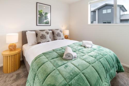 基督城Upper Riccarton dream - 2 bed 2 bath w/carpark的一间卧室配有一张带绿毯的大床