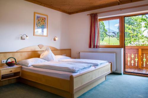 斯拉德明巴郎滋特夫旅馆的卧室在窗户前配有一张大床