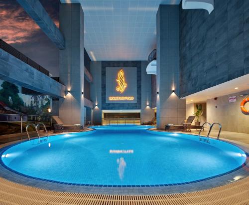 莎阿南Mardhiyyah Hotel and Suites的酒店大堂的大型游泳池