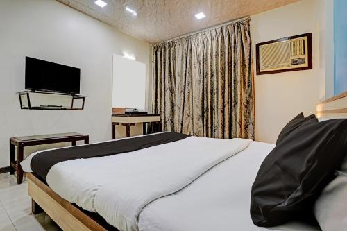 孟买Collection O Guru Heritage Kalamboli的酒店客房,配有床和电视