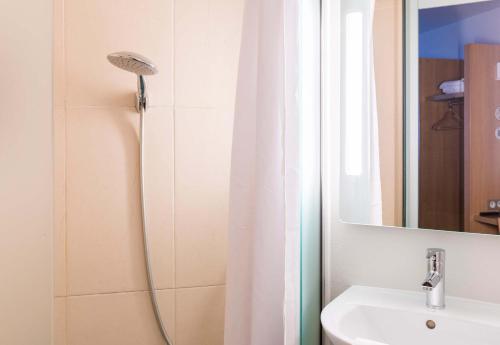 布尔日B&B HOTEL Bourges 1的浴室配有淋浴帘和盥洗盆。