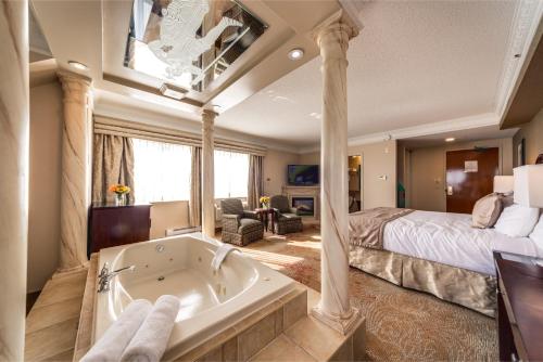 马卡姆蒙地卡罗及套房市中心马克姆酒店的卧室配有床和浴缸