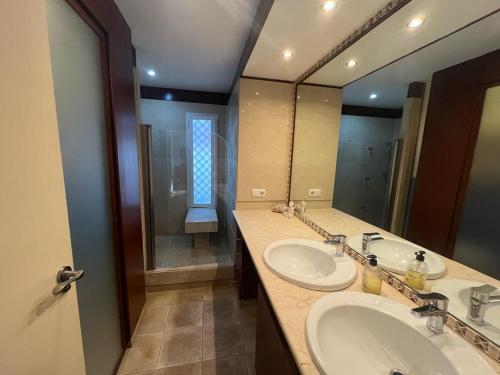 托雷德本纳贾尔邦Yoga House的一间带两个盥洗盆和大镜子的浴室