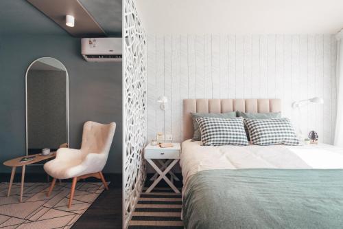 蒙得维的亚Diseño en Punta Carretas的一间卧室配有一张床、一把椅子和一张书桌