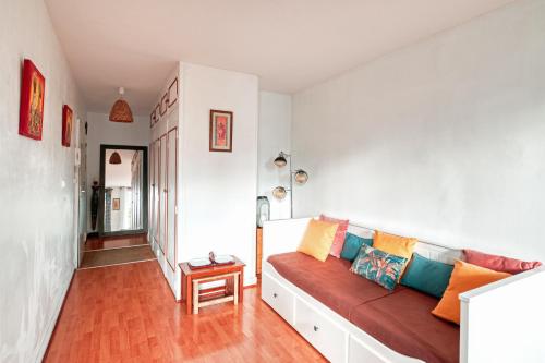 维勒瑞夫Le Marx - Appt 2 chambres的客厅配有带色彩缤纷枕头的沙发