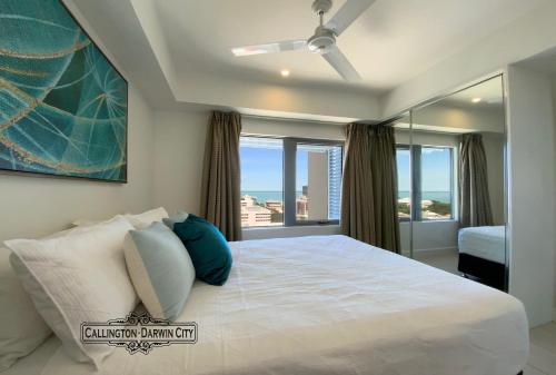 达尔文“CALLINGTON” Darwin City @PenthousePads的一间卧室设有一张大床和大窗户