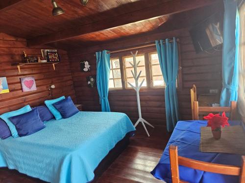 科蒂略La Maxada Luz Maria的一间卧室设有蓝色的床和窗户。