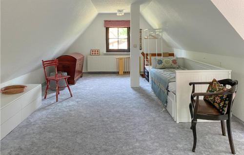 布格施塔加德2 Bedroom Beautiful Home In Burg Stargard的阁楼卧室配有1张床和1把椅子
