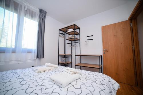 兹拉蒂博尔Zlatibor Breza Apartment and Spa的一间卧室配有带毛巾的床