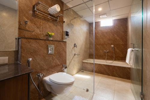 希莫加Malnad Shire Eco Resort的一间带卫生间和玻璃淋浴间的浴室