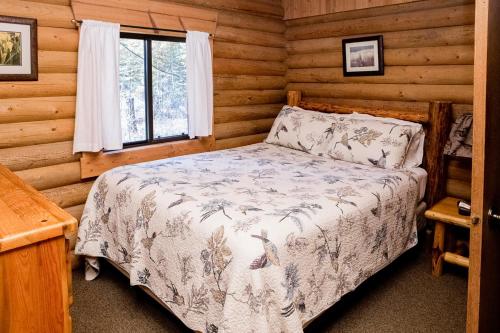 比格福克Experience Montana Cabins - Birdsong #2的小木屋内一间卧室,配有一张床