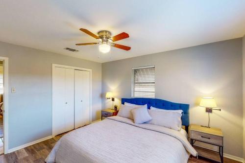 韦科New Cozy Home 10 Min to Magnolia and Baylor的一间卧室配有一张带吊扇的床