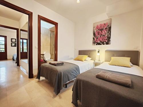 EsteponaVillacana Playa Elena的一间卧室配有两张床和镜子
