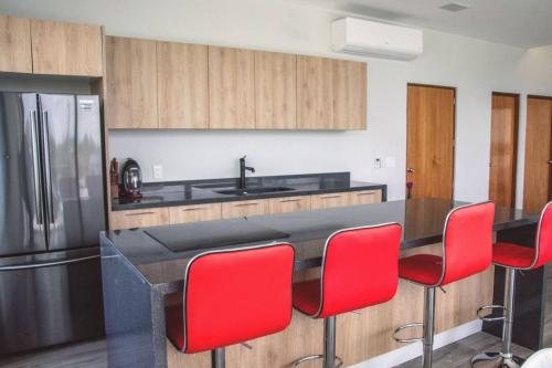 奥尔沃克斯岛Casa de tus Sueños的厨房配有红色椅子和冰箱
