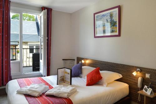 克莱西赛特诺曼德之家酒店的一间卧室设有两张床和窗户。