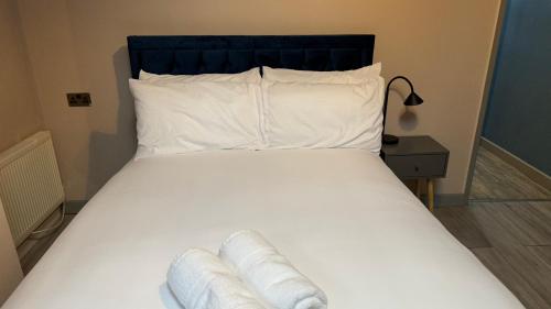 BloxwichOne Bedroom Apartment in Walsall Sleeps 4 FREE WIFI By Villazu的一张带白色床单和枕头的床