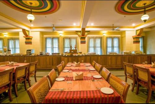 蒙纳The RaaRees Resort - A Hidden Resort in Munnar的大型用餐室配有长桌和椅子
