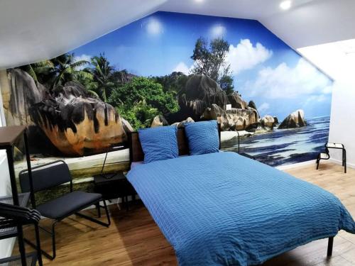 Le temps d'une pause的一间卧室设有蓝色墙壁和恐龙壁画